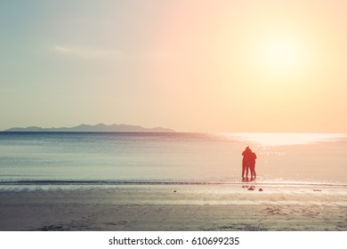 friends walking in the sea beach, lonely summer season vintage color tone.