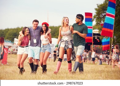 Friends Walking Through A Music Festival Site