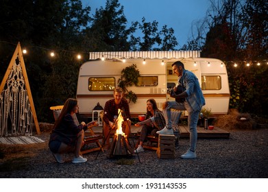 Friends Warming Themselves By The Bonfire, Camping