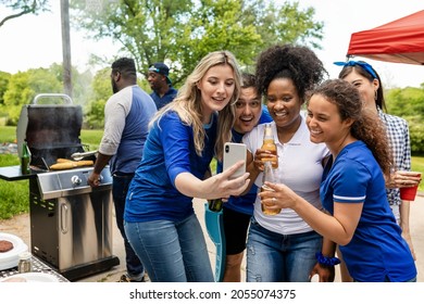 Friends Watching The Game On A Phone At A Tailgate Party