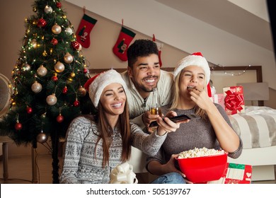 Friends watching movie and having fun at Christmas eve.