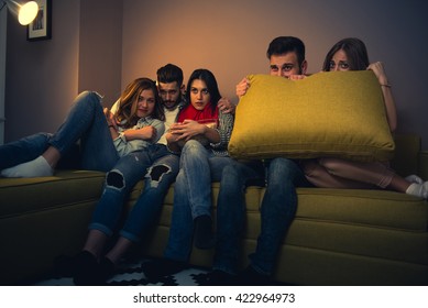 Friends Watching A Scary Movie At Home.