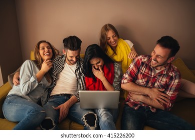 Friends watching something funny on a computer. Blurry movement during the laughing. - Shutterstock ID 415226200