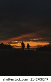 Friends Watching Sunrise Over Tropical Sea In Yabucoa, Puerto Rico