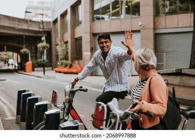 Friends Waving Goodbye On A Bike