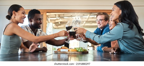 Friends, Wine Tasting And Toasting Alcohol With Drinking Glasses In Restaurant On Farm, Winery Estate Or Countryside Distillery. Diversity, Bonding Or Happy Men And Women Enjoying Vineyard Red