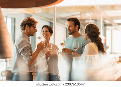 Friends wine tasting white wine in winery tasting room - Powered by Shutterstock