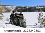 Friends (woman) watch the view of a freezing lake, in Shawinigan, in Canada (Quebec district) 