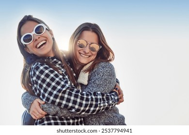 Friends, women and outdoor hug with sunglasses, bonding and travel to Berlin on weekend trip. People, together and peace on vacation by blue sky, embrace and united in sisterhood or relationship - Powered by Shutterstock