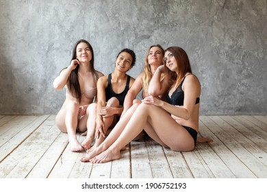 Friendship, Beauty, Body Positive And People Concept - Group Of Happy Women Different In Underwear Over Gray Background