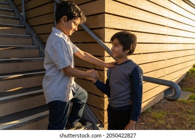 Friendship Concept. Two Boys Shaking Hands. Hand On Shoulder. Diversity South Asian Kids. Friends Supporting Or Doing Teamwork.  