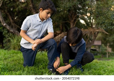 Friendship Concept. Two Young Boys At Park. Kid Helping. Child Tying Shoe Laces. South Asian Kids Caring For Each Other. Showing Care.