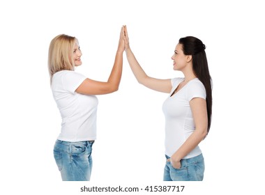 friendship, diverse, body positive, gesture and people concept - group of happy different women in white t-shirts making high five - Powered by Shutterstock