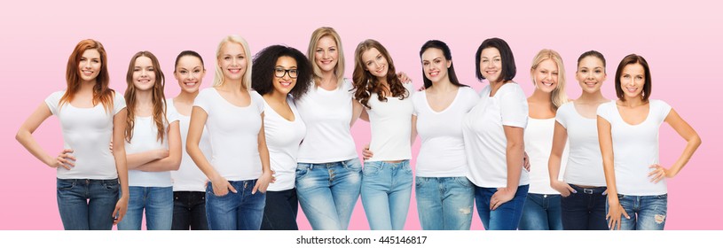 friendship, diversity, body positive and people concept - group of happy women of different age size and ethnicity in white t-shirts hugging over pink background