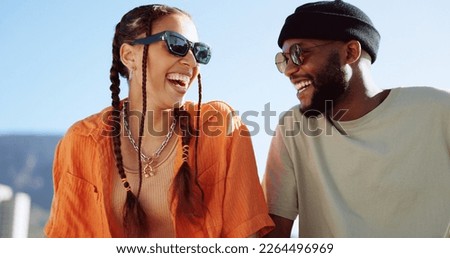 Friendship, flirting and couple with sunglasses in city sitting on building rooftop laughing. Love, friends and romance, urban dating and freedom for gen z woman and man with smile on crazy fun date.