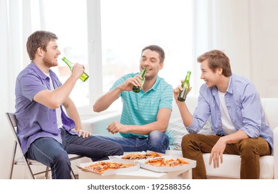 Friendship, Food And Leisure Concept - Smiling Male Friends With Beer And Pizza Hanging Out At Home