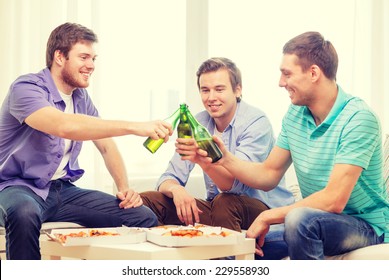 Friendship, Food And Leisure Concept - Smiling Male Friends With Beer And Pizza Hanging Out At Home