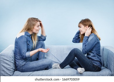 Friendship, Human Relations Concept. Two Serious Women Friends Or Sisters Wearing Jeans Shirts Having Conversation, Talking About Solving Problem.