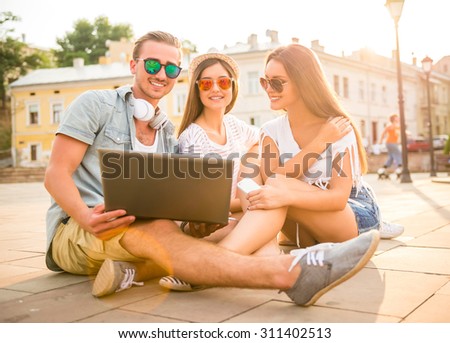 Similar – Young happy people looking tablet over table