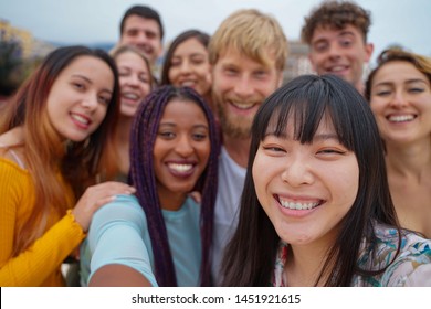 Friendship, leisure and summer concept - group of happy smiling friends outdoors. tourism, travel, people, leisure and technology concept. - image