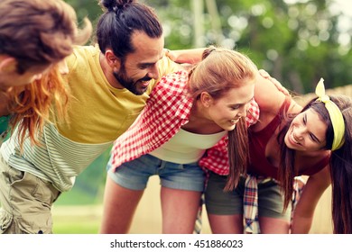 Friendship, Leisure, Summer And People Concept - Group Of Smiling Friends Outdoors