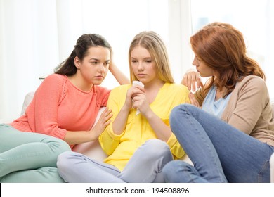 Friendship And People Concept - Two Teenage Girls Comforting Another After Break Up