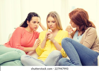 Friendship And People Concept - Two Teenage Girls Comforting Another After Break Up