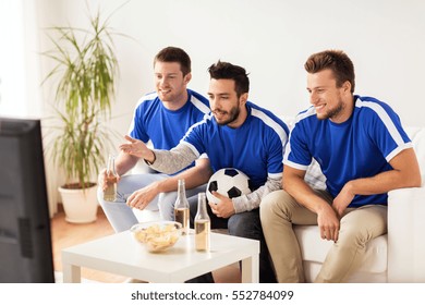 Friendship, Sport, People And Entertainment Concept - Happy Male Friends Or Football Fans Watching Soccer On Tv At Home