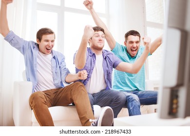 Friendship, Sports And Entertainment Concept - Happy Male Friends Supporting Football Team At Home