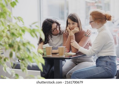 friendship and support in a difficult situation, three female friends discuss the problem and support each other, depression and sadness in a woman, group psychotherapy and support from friends and - Shutterstock ID 2161700679