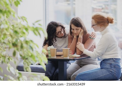 friendship and support in a difficult situation, three female friends discuss the problem and support each other, depression and sadness in a woman, group psychotherapy and support from friends and - Shutterstock ID 2163315439