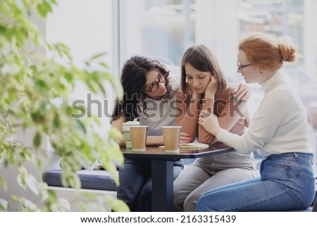 friendship and support in a difficult situation, three female friends discuss the problem and support each other, depression and sadness in a woman, group psychotherapy and support from friends and