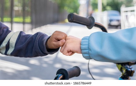 Friendship, Support, Equality And Diversity. Kids Of Different Races Greeting Each Other With Fist Bump. 