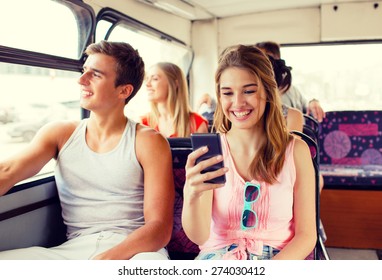 friendship, travel, summer vacation, technology and people concept - smiling couple with smartphone traveling by tour bus and making selfie - Powered by Shutterstock