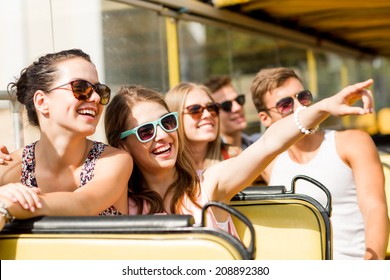 Friendship, Travel, Vacation, Summer And People Concept - Group Of Smiling Friends Traveling By Tour Bus