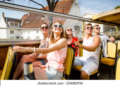 Friendship, Travel, Vacation, Summer And People Concept - Group Of Smiling Friends Traveling By Tour Bus