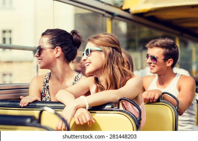 Friendship, Travel, Vacation, Summer And People Concept - Group Of Smiling Friends Traveling By Tour Bus