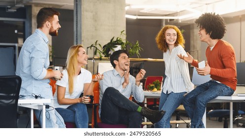 Friendship at workplace. Diverse millennial people having good talk at coworking space, panorama - Powered by Shutterstock