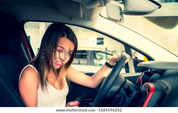 Fright face of woman,\
driving car. Closeup portrait displeased angry pissed off\
aggressive woman driving car. Emotional intelligence concept.\
Negative human\
expression