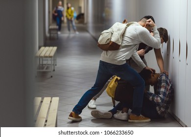 frightened african american schoolboy being bullied in school corridor - Powered by Shutterstock