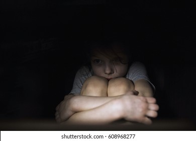 Frightened Child In The Dark