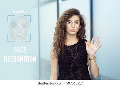 Frightened curly girl holds open hand, biometric verification. Face recognition.