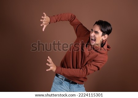 Frightened guy posing in a photo studio. Fear and horror. Stockfoto © 