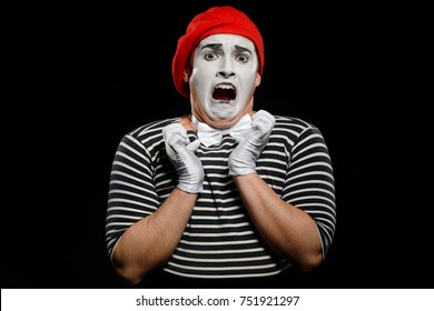 Frightened Male Mime, Isolated On Black. Lively Emotions Of An Actor Performing A Pantomime. Watching Scary Movie Concept.