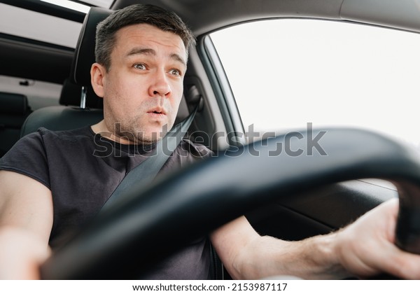 a frightened man drives a car on the highway. car\
journey. driving school. fatigue from a long road trip. a dangerous\
accident on the road. 