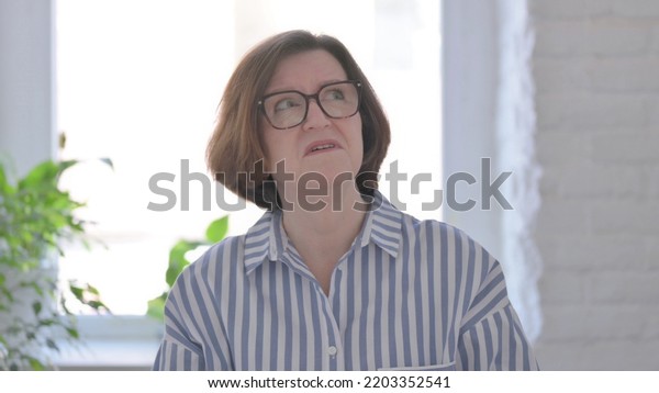 Frightened Senior\
Woman Looking around in\
Fear