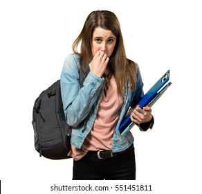 Frightened teen student girl holding books and