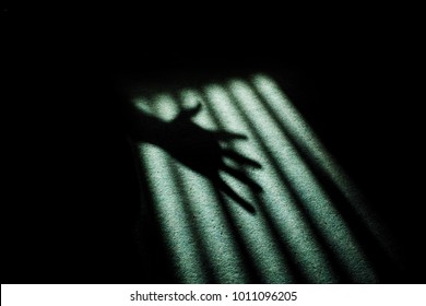 Frightening And Scary Ghostly Hand Shadow Silhouette With A Creepy Film Noir Atmosphere.