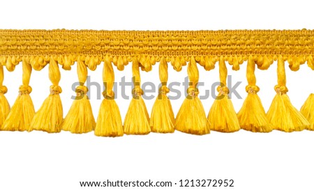Fringe. Yellow braid with tassels. Isolated on white background.