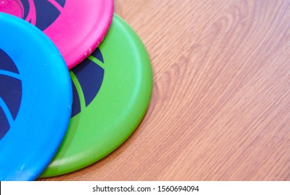 Frisbee golf discs on wooden floor